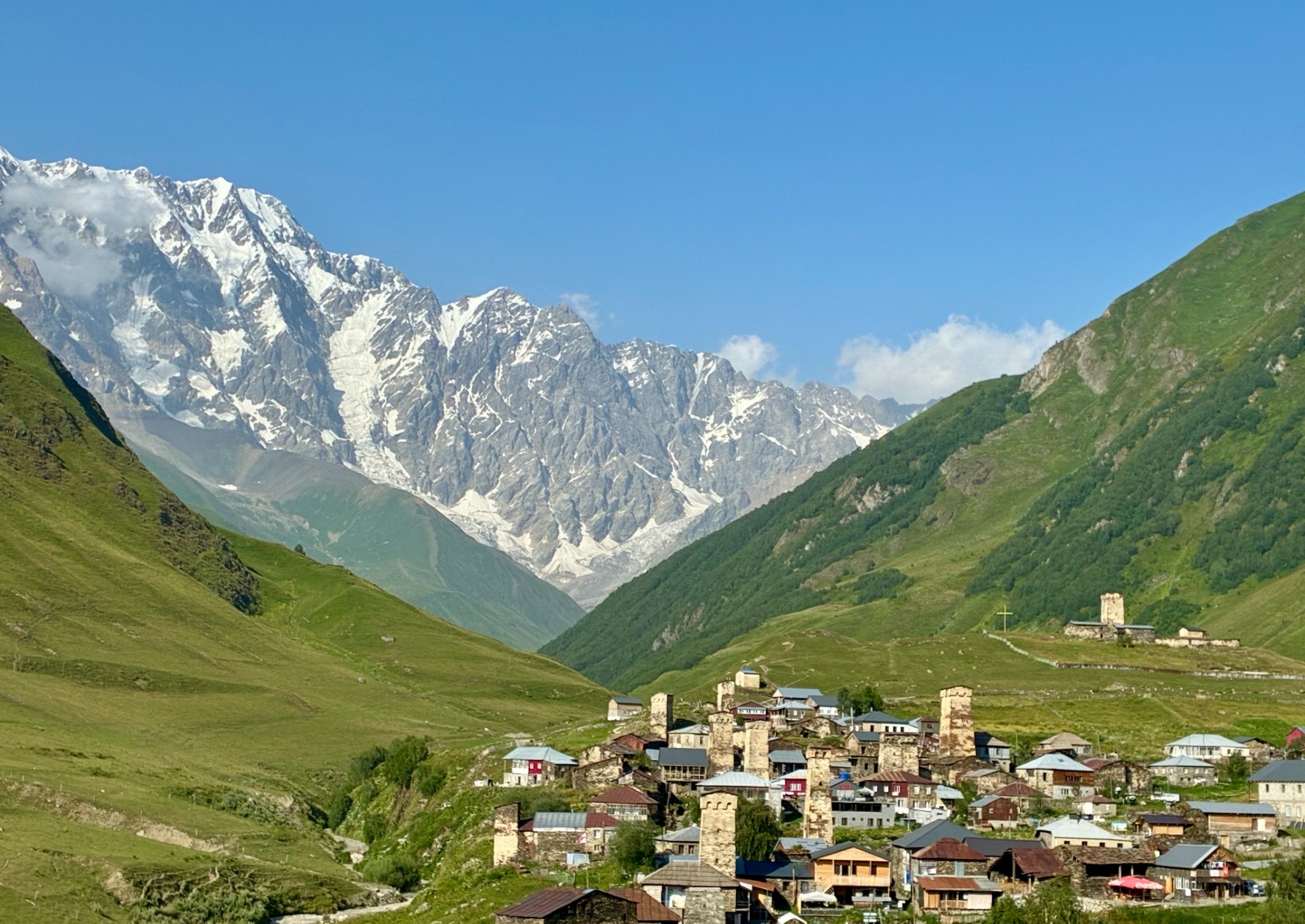 Caucasus village beneath mountain peaks